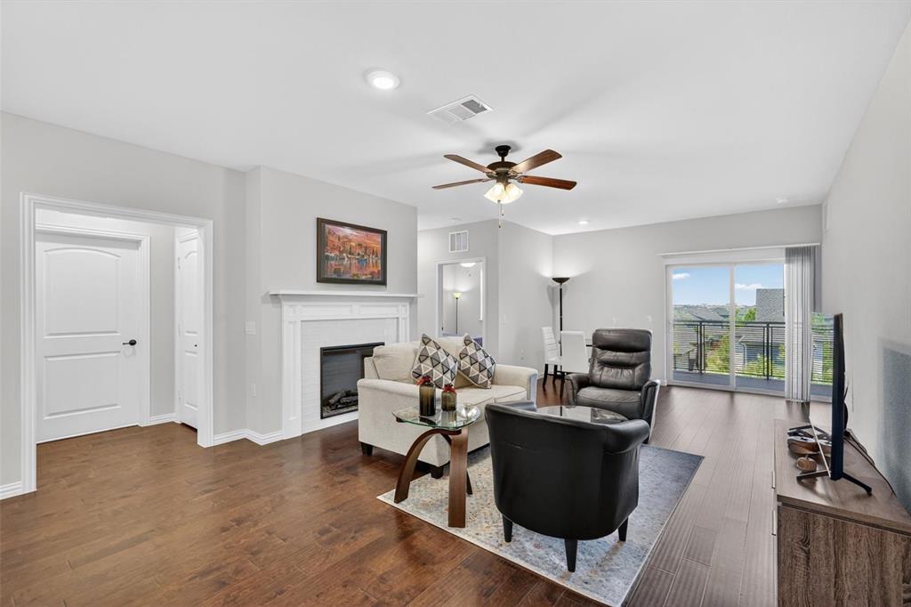 651 Watters Road, Unit 5305 Allen, TX 75013 - Photo 10 of 40 a living room with furniture a fireplace and a flat screen tv