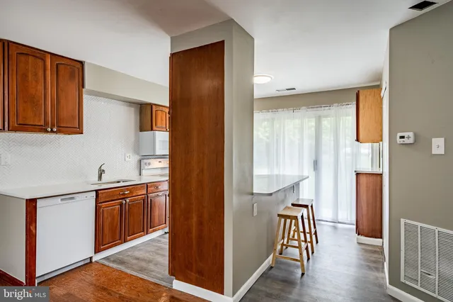 a view of a kitchen with a sink and a refrigerator