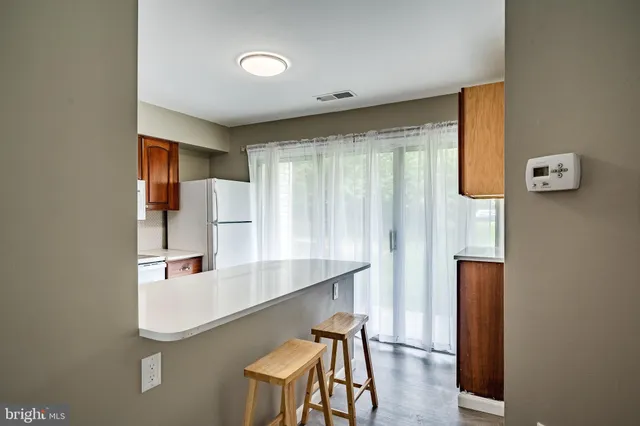 a view of a kitchen with a refrigerator a sink and dishwasher