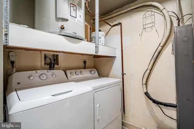 a kitchen with stainless steel appliances granite countertop a sink and a refrigerator