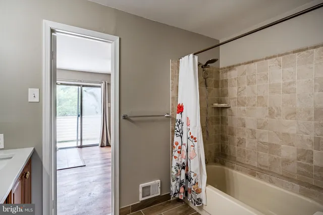a bathroom with a granite countertop double vanity sink and a mirror