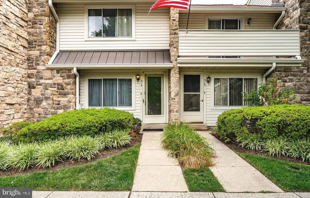 a view of a house with potted plants
