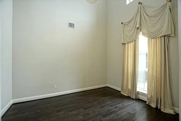 a view of entrance door with wooden floor