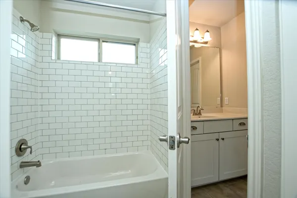 a bathroom with a bathtub and a shower
