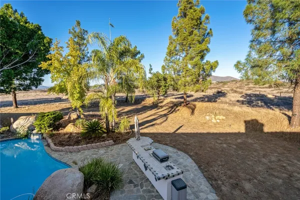 a view of road with card and parked cars
