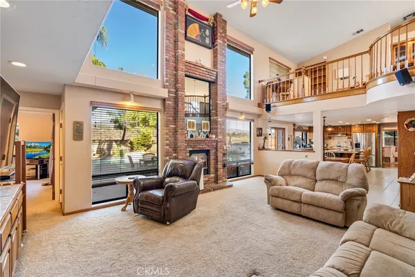 a living room with a fireplace and a flat screen tv