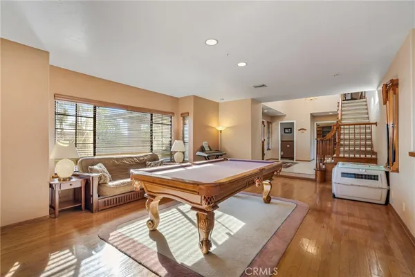 a kitchen with stainless steel appliances granite countertop a table and chairs in it