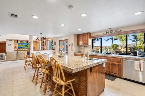 a kitchen with a sink a counter top space cabinets and stainless steel appliances