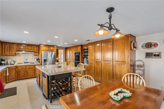 a kitchen with stainless steel appliances granite countertop a sink and a refrigerator