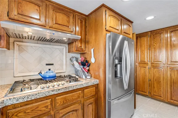 a bathroom with a granite countertop sink and a window