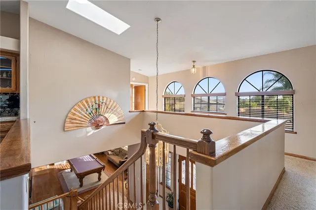a bed sitting in a spacious bedroom next to a window