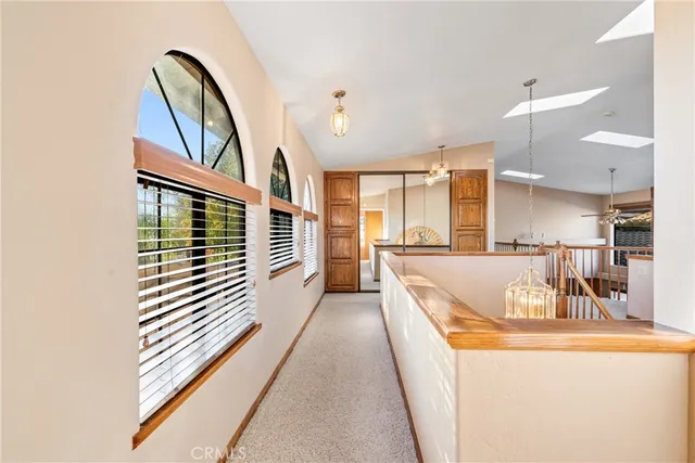 a large spacious bathroom with a granite countertop sink a mirror a bathtub and next to a window