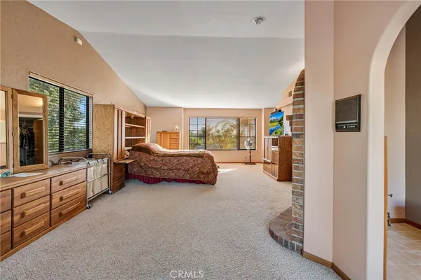 a bathroom with a tub a sink and a large mirror
