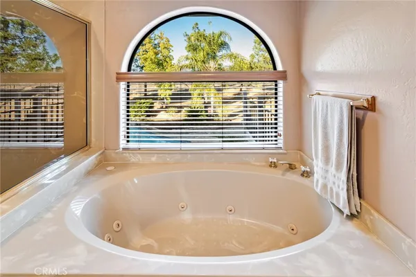a bathroom with a granite countertop sink a toilet and a mirror