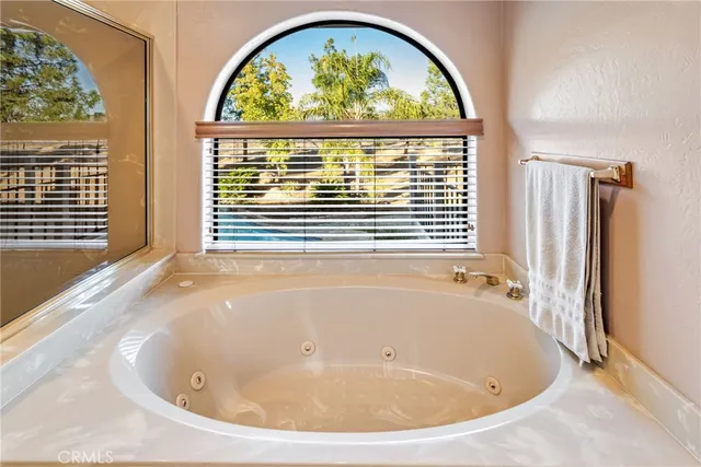 a bathroom with a granite countertop sink a toilet and a mirror