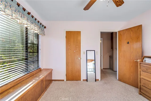 a bathroom with a granite countertop sink mirror vanity and toilet
