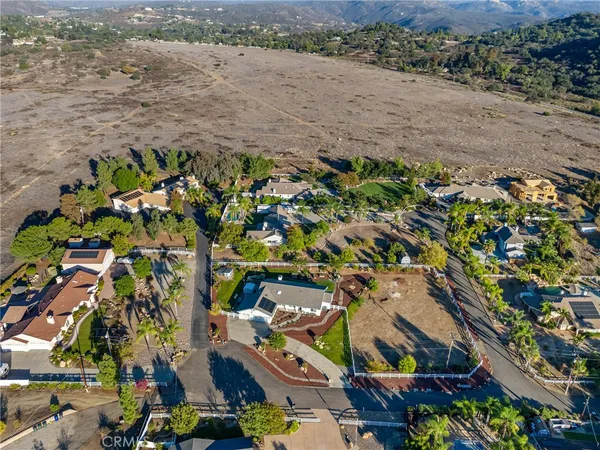 a view of dirt yard with a large tree