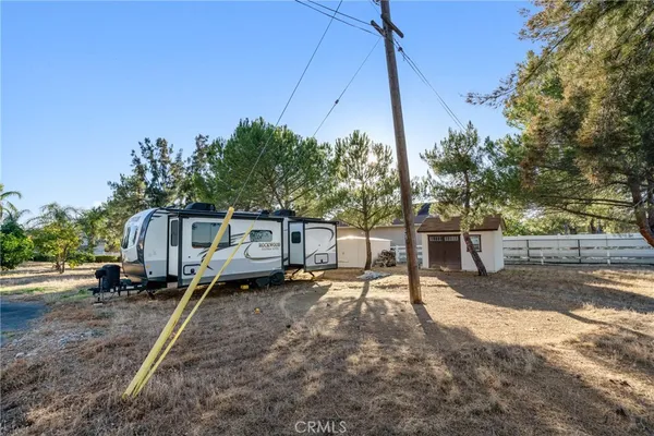 a row of palm trees in front of house