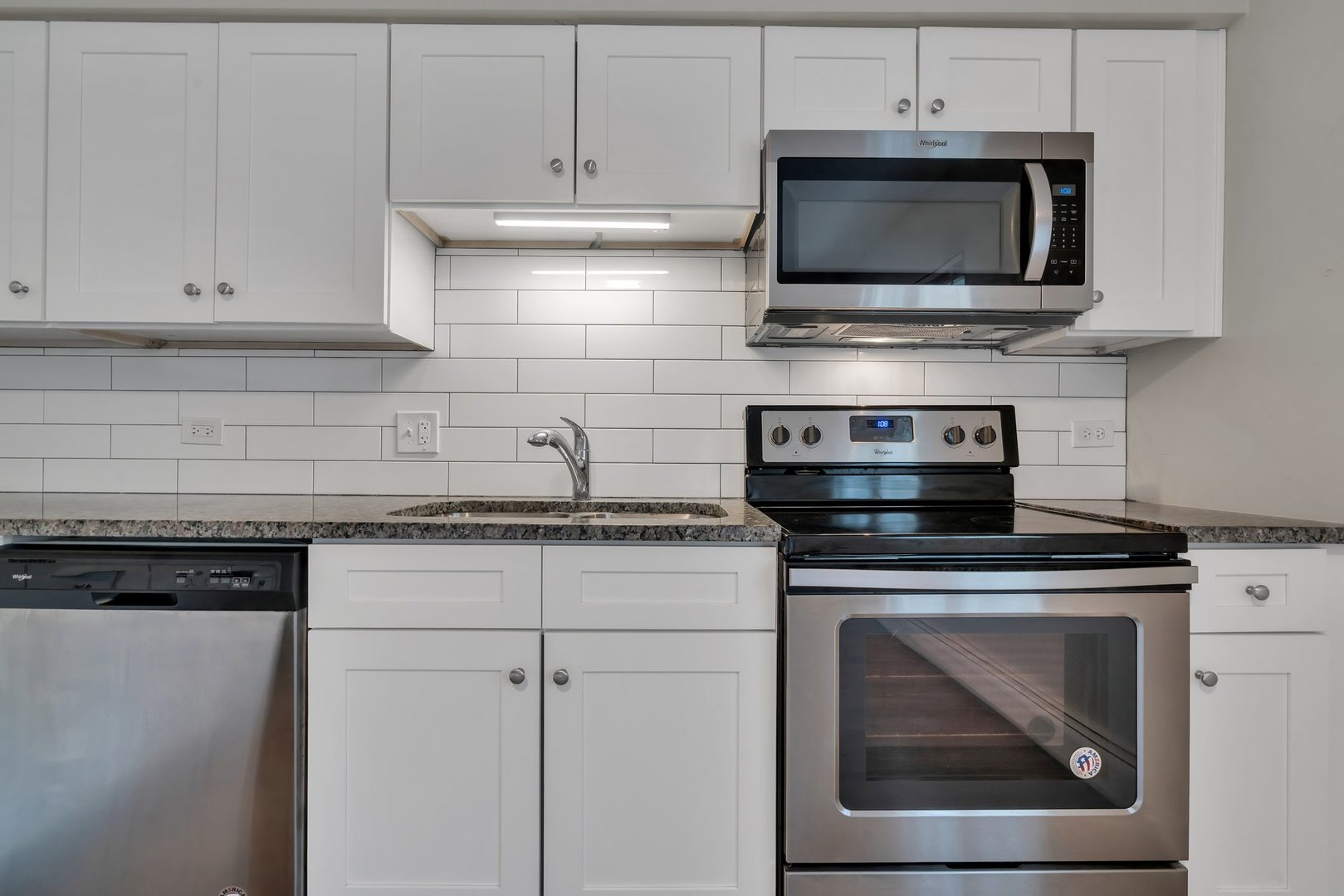 42 South Waiola Avenue, Unit 2 La Grange, IL 60525 - Photo 2 of 13 a kitchen with stainless steel appliances granite countertop a stove microwave and cabinets
