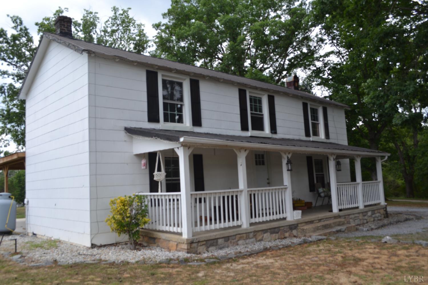 6387 Red House Road Rustburg, VA 24588 - Photo 3 of 38 a front view of a house with a garden