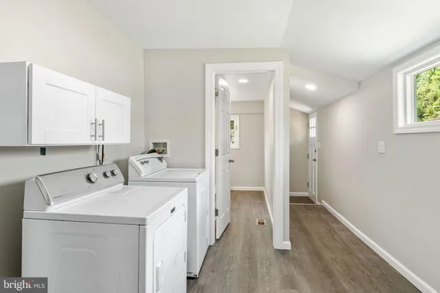 a view of a storage & utility room with two washing machine