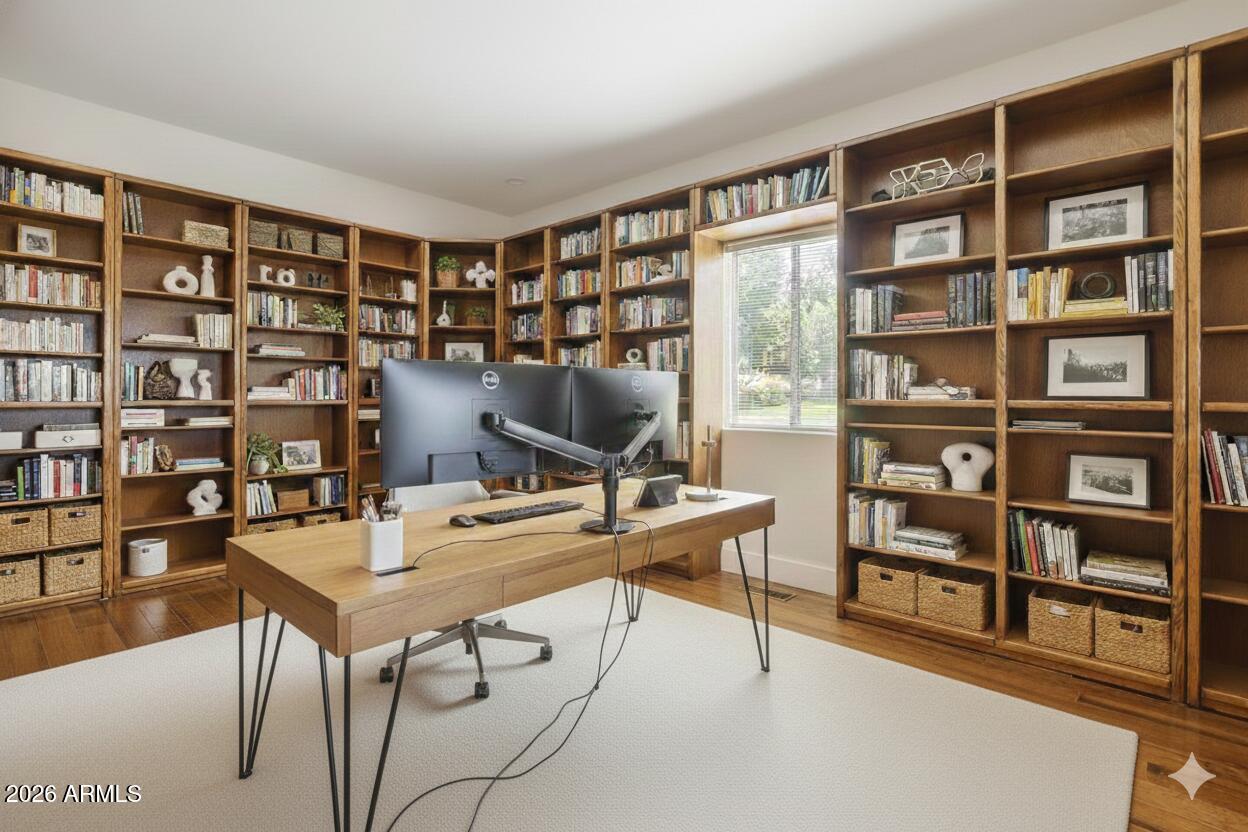 1980 Koch Ranch Road Cornville, AZ 86325 - Photo 21 of 41 a view of a workspace with furniture and a bookshelf