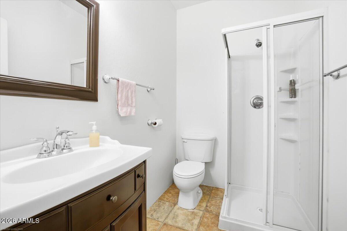 1980 Koch Ranch Road Cornville, AZ 86325 - Photo 23 of 41 a bathroom with a sink toilet a mirror and shower