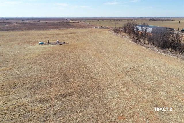 a view of an empty room and wooden floor
