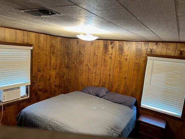 a bedroom with a bed and a window