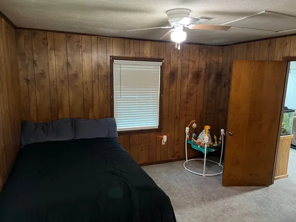 a bedroom with a bed and a table