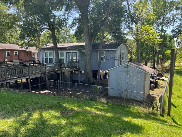 a view of house with a backyard