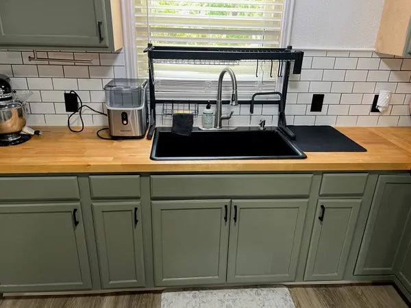 a kitchen with a sink and a stove next to a cabinet