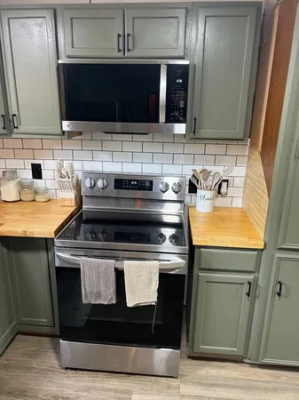 a kitchen with a stove and a microwave