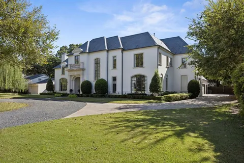 an aerial view of a house with a big yard