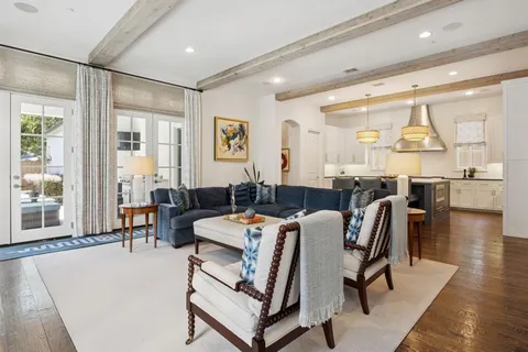 a kitchen with a table chairs sink and cabinets