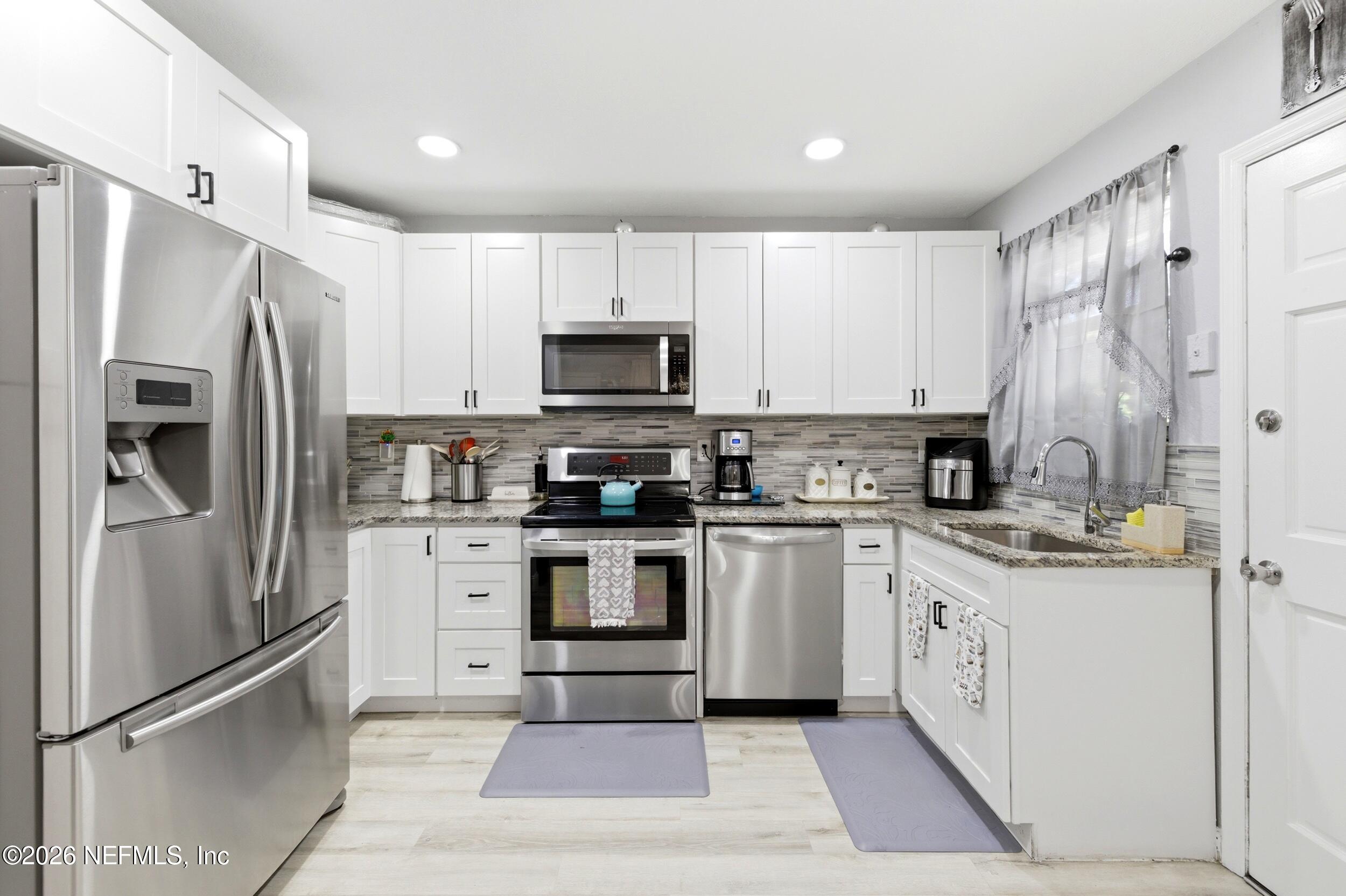 1955 Layton Road Jacksonville, FL 32211 - Photo 14 of 35 a kitchen with stainless steel appliances cabinets a sink and a counter top space