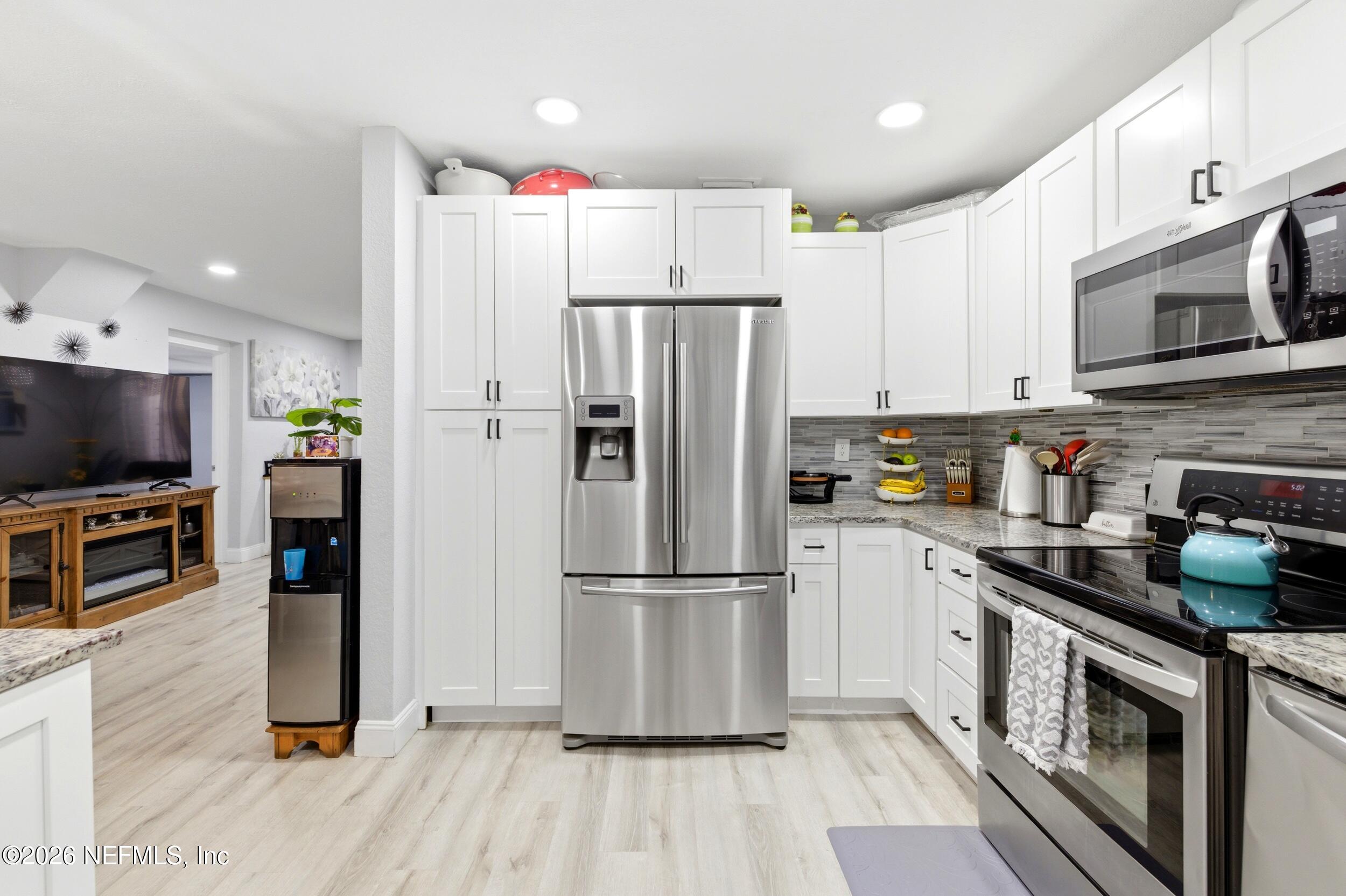 1955 Layton Road Jacksonville, FL 32211 - Photo 16 of 35 a kitchen with stainless steel appliances a refrigerator microwave and sink