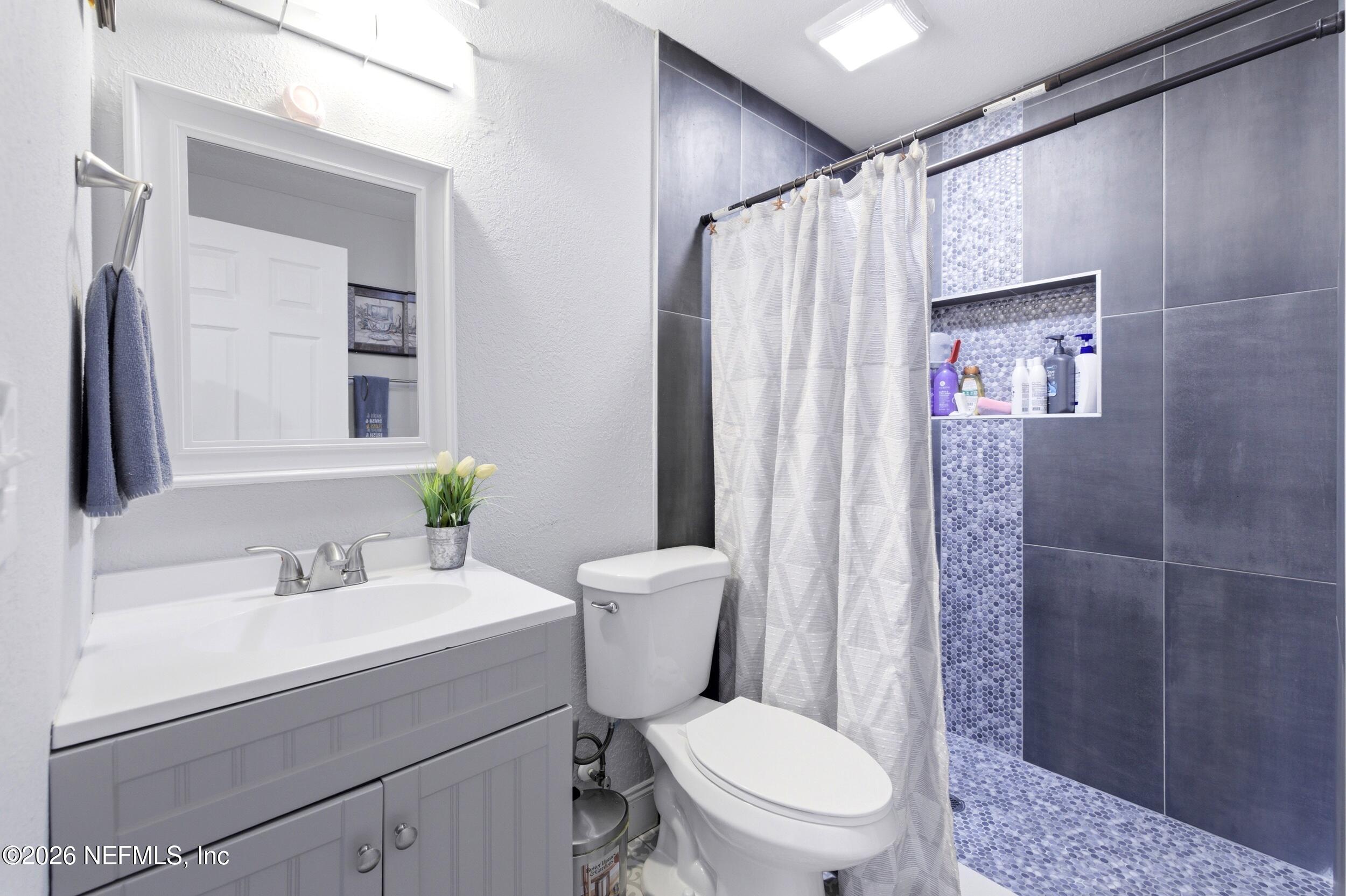 1955 Layton Road Jacksonville, FL 32211 - Photo 21 of 35 a bathroom with a sink toilet and shower
