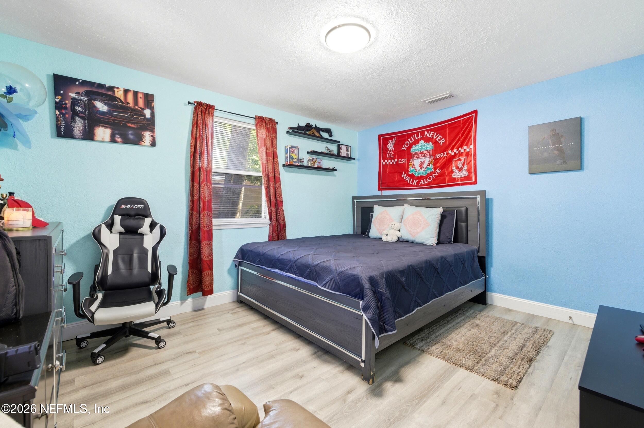 1955 Layton Road Jacksonville, FL 32211 - Photo 25 of 35 a bedroom with a bed and wooden floor