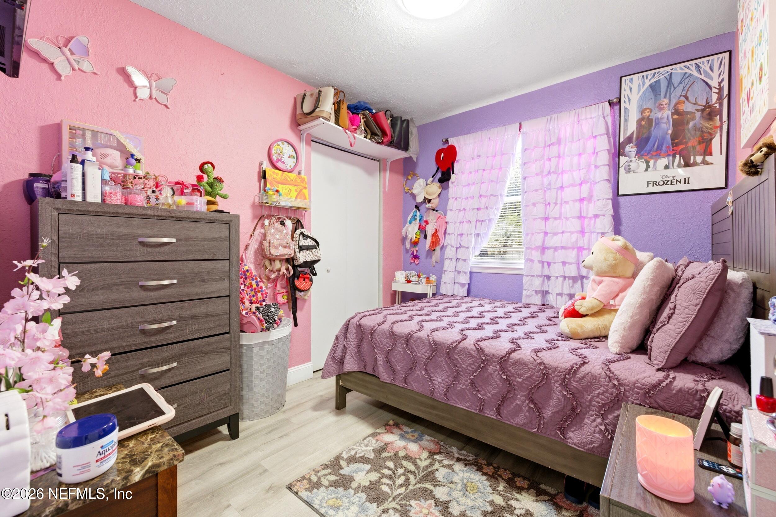 1955 Layton Road Jacksonville, FL 32211 - Photo 27 of 35 a bedroom with a bed and a chandelier