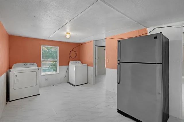 a kitchen with stainless steel appliances granite countertop a sink dishwasher a stove and a microwave oven with white cabinets