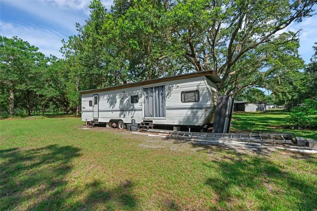 a kitchen with stainless steel appliances granite countertop a sink dishwasher a stove and a microwave oven with white cabinets