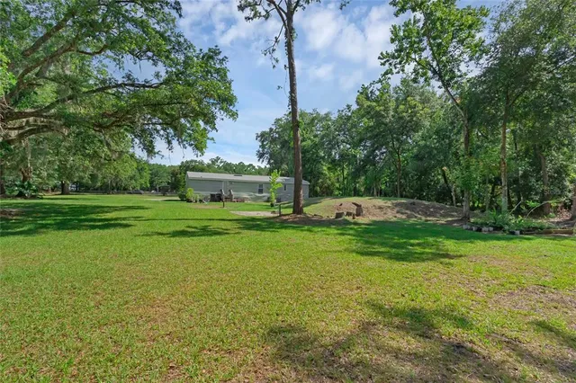 a view of outdoor space with deck and trees