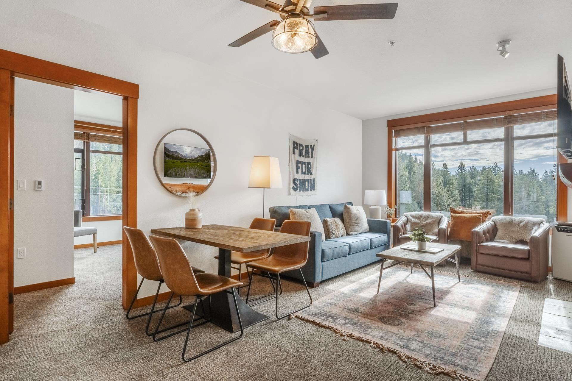 a living room with furniture a rug and a large window