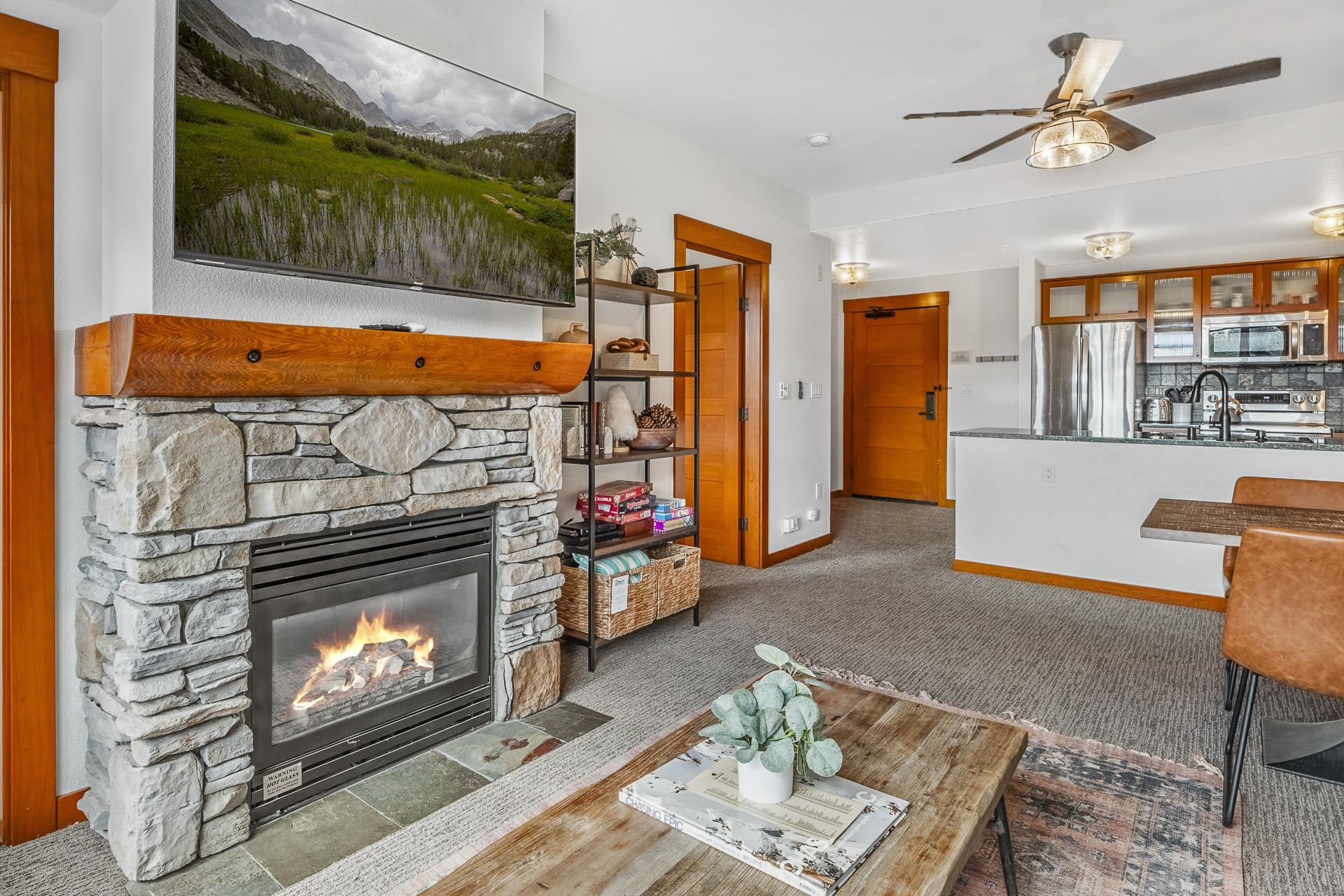6201 Minaret Road, Unit 2311 Mammoth Lakes, CA 93546 - Photo 4 of 40 a living room with furniture a flat screen tv and a fireplace
