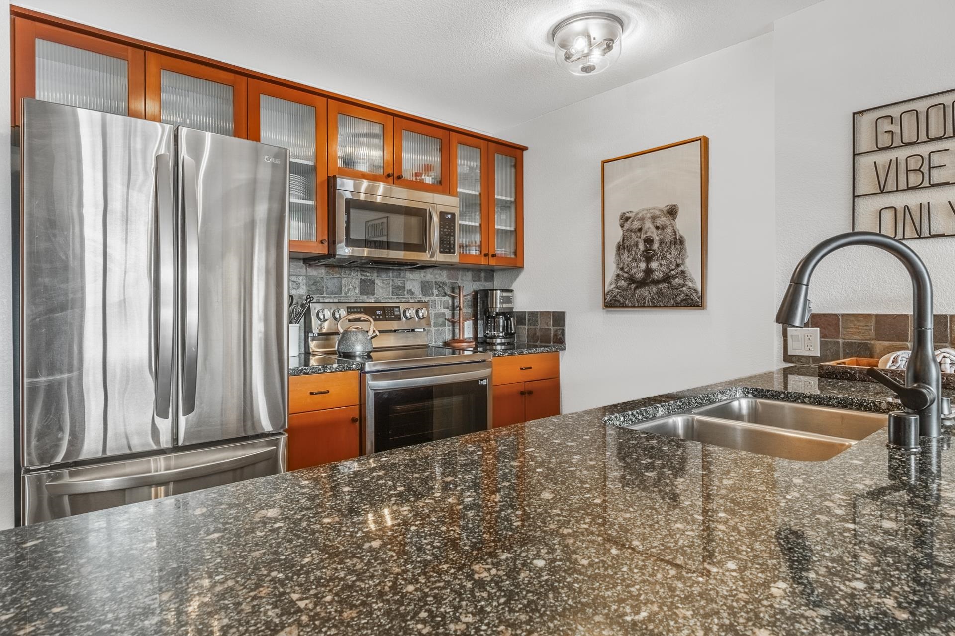 6201 Minaret Road, Unit 2311 Mammoth Lakes, CA 93546 - Photo 7 of 40 a kitchen with stainless steel appliances granite countertop a refrigerator a stove top oven a sink and dishwasher