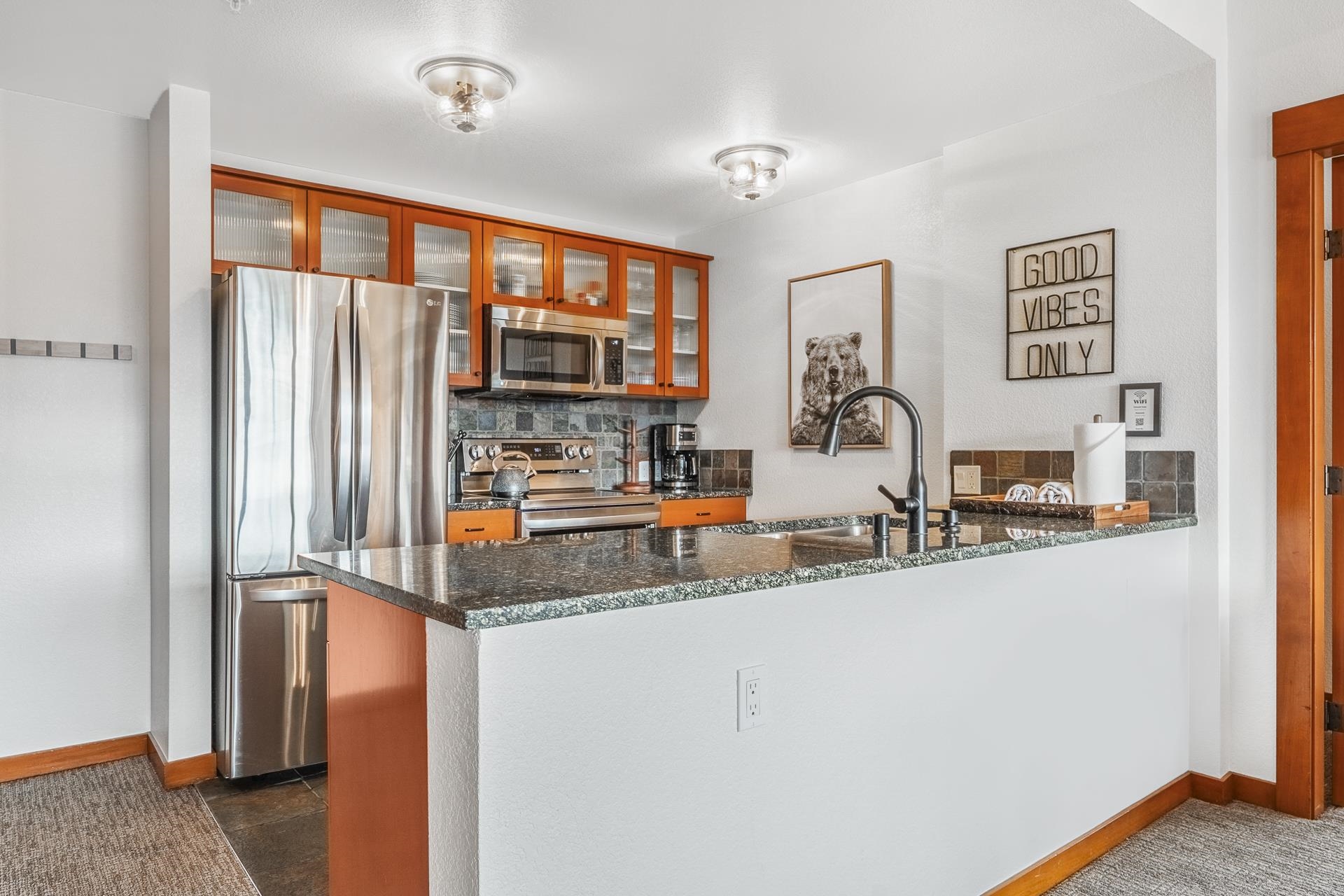 6201 Minaret Road, Unit 2311 Mammoth Lakes, CA 93546 - Photo 10 of 40 a kitchen with stainless steel appliances granite countertop a refrigerator and a sink