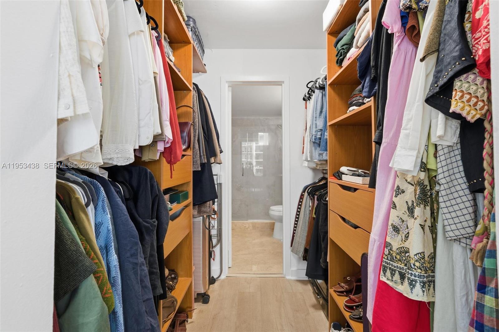200 Southeast 15th Road, Unit 11H Miami, FL 33129 - Photo 13 of 25 a view of walk in closet with clothes and shoes
