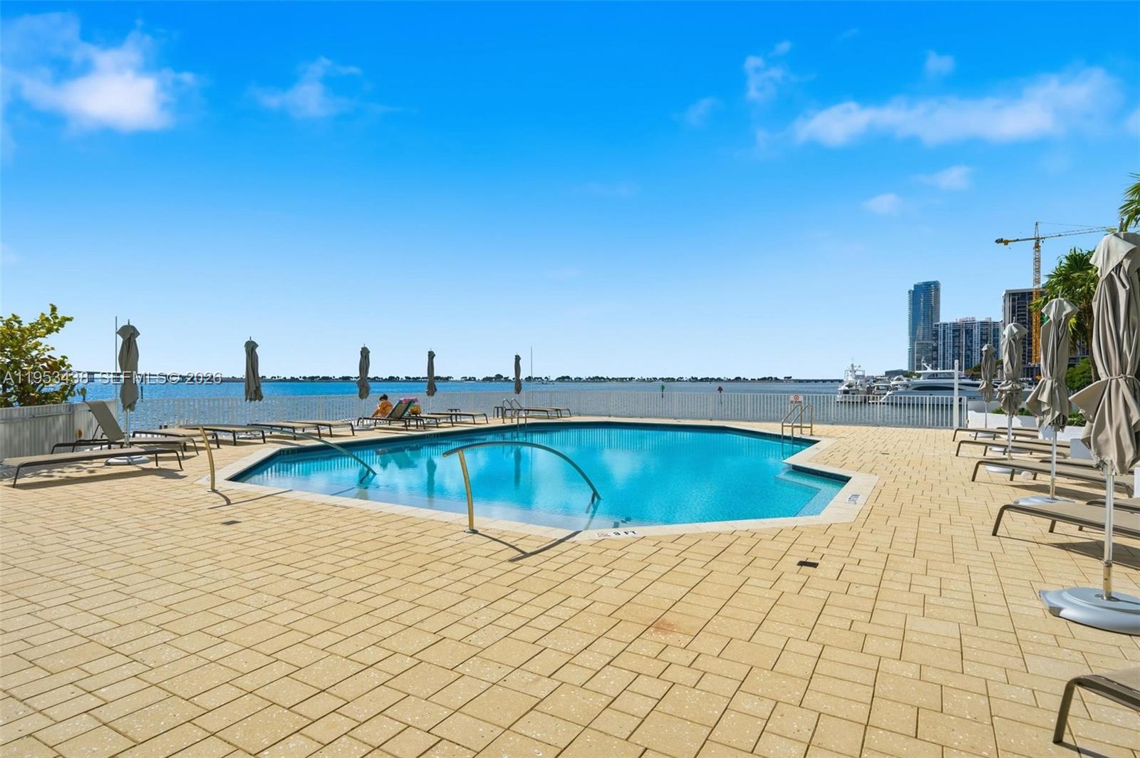 200 Southeast 15th Road, Unit 11H Miami, FL 33129 - Photo 17 of 25 a view of a swimming pool and lounge chair