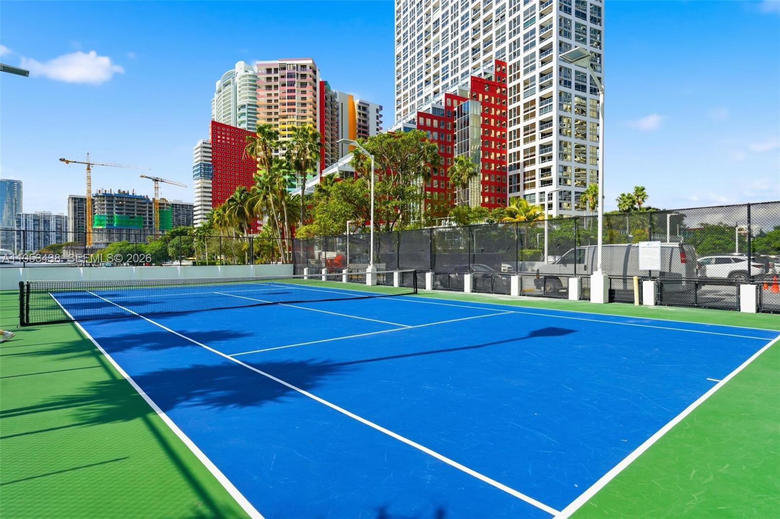 200 Southeast 15th Road, Unit 11H Miami, FL 33129 - Photo 19 of 25 a view of a tennis ground with large trees